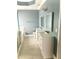 Bathroom with tile floors, double vanity sinks, and a shower with a glass door at 971 Martin Se St, Atlanta, GA 30315