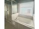 Bathroom with a glass door shower and large soaking tub next to a window at 971 Martin Se St, Atlanta, GA 30315
