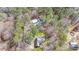 An aerial view of the property shows a wooded lot with multiple outbuildings and a long driveway at 4751 Bill Cheek Rd, Auburn, GA 30011