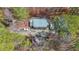 An aerial view of a home nestled in a forested area, surrounded by lush trees and a private yard at 4751 Bill Cheek Rd, Auburn, GA 30011