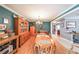 A formal dining room features hardwood flooring, an ornate hutch and decor, and views into another living area at 4751 Bill Cheek Rd, Auburn, GA 30011