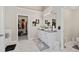 Elegant bathroom with double vanity, marble floors, and walk-in closet, offering style and functionality at 7178 Cavender Sw Dr, Atlanta, GA 30331