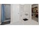 Modern bathroom featuring tile flooring, shower, soaking tub and walk-in closet at 7178 Cavender Sw Dr, Atlanta, GA 30331