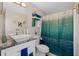 Bathroom featuring a vanity sink, toilet, and a blue and green designed shower curtain at 7178 Cavender Sw Dr, Atlanta, GA 30331
