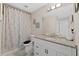 Well-lit bathroom with granite vanity, patterned shower curtain, and modern fixtures at 7178 Cavender Sw Dr, Atlanta, GA 30331