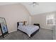 Cozy bedroom features vaulted ceiling, plush carpet, and a comfortable bed, creating a relaxing retreat at 7178 Cavender Sw Dr, Atlanta, GA 30331