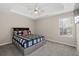 Cozy bedroom featuring a ceiling fan, a window and neutral-toned carpet at 7178 Cavender Sw Dr, Atlanta, GA 30331