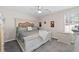 Comfortable bedroom with neutral tones, a ceiling fan, and well-lit window at 7178 Cavender Sw Dr, Atlanta, GA 30331