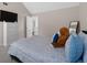 Bedroom featuring carpeted floors, large dresser, a queen-size bed, and a TV for relaxation and entertainment at 7178 Cavender Sw Dr, Atlanta, GA 30331