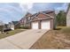 Side angle of a brick two-story home with a concrete driveway and a two-car garage at 7178 Cavender Sw Dr, Atlanta, GA 30331