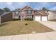 Beautiful two-story brick home featuring a two-car garage and well-manicured lawn at 7178 Cavender Sw Dr, Atlanta, GA 30331