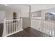 Bright upstairs hallway with white railing and arch window at 7178 Cavender Sw Dr, Atlanta, GA 30331