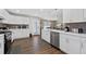 Modern kitchen with white cabinets, stainless steel appliances, and hardwood floors at 7178 Cavender Sw Dr, Atlanta, GA 30331