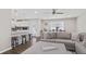 Open-concept space shows living area with kitchen, breakfast bar, and stylish gray sofa at 7178 Cavender Sw Dr, Atlanta, GA 30331
