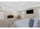 Spacious main bedroom with carpeted floors, tray ceilings, large bed, fan and natural light at 7178 Cavender Sw Dr, Atlanta, GA 30331
