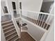 Well-lit staircase with hardwood steps, providing a seamless transition between floors in the home at 7178 Cavender Sw Dr, Atlanta, GA 30331