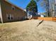 Spacious backyard features a wooden fence, mature trees, and a patio area great for relaxing outdoors at 2702 Brookefield Nw Ln, Kennesaw, GA 30152