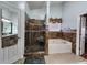 Bathroom featuring a glass shower door, a soaking tub, and a vanity with a large mirror at 2702 Brookefield Nw Ln, Kennesaw, GA 30152