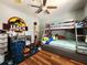 Bedroom featuring a bunkbed, wood floors, a ceiling fan, and space decor at 2702 Brookefield Nw Ln, Kennesaw, GA 30152