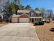 Inviting two-story home with a three-car garage, well-manicured front yard, and a charming front porch with seasonal wreath at 2702 Brookefield Nw Ln, Kennesaw, GA 30152