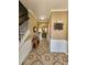 Inviting foyer with decorative tiled floors, wainscoting, staircase, and views into the kitchen through arched doorway at 2702 Brookefield Nw Ln, Kennesaw, GA 30152