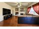 Spacious living room featuring a fireplace, built-in shelving, and large windows for natural light, perfect for relaxation at 2702 Brookefield Nw Ln, Kennesaw, GA 30152