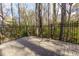 Backyard patio and wooded property line featuring a fence providing an added layer of privacy at 633 N Fairfield Dr, Peachtree City, GA 30269