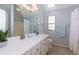 Bathroom with large mirror and vanity with white cabinets, as well as a skylight at 633 N Fairfield Dr, Peachtree City, GA 30269