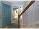 View of the entryway with a teal front door and staircase at 633 N Fairfield Dr, Peachtree City, GA 30269