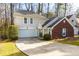 Two-story home featuring a brick facade, two-car garage, and well-manicured landscaping at 633 N Fairfield Dr, Peachtree City, GA 30269