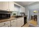 Kitchen features white cabinets, granite countertops, and stainless steel appliances at 633 N Fairfield Dr, Peachtree City, GA 30269