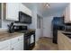 Kitchen features white cabinets and black appliances, plus a laundry closet at 633 N Fairfield Dr, Peachtree City, GA 30269