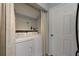 Functional laundry area with white appliances and convenient storage, designed for efficient laundry tasks at 633 N Fairfield Dr, Peachtree City, GA 30269