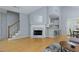 Living room with a fireplace, hardwood floors, and bar seating in view at 633 N Fairfield Dr, Peachtree City, GA 30269