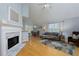 Open concept living room featuring a fireplace and dining area with natural light at 633 N Fairfield Dr, Peachtree City, GA 30269