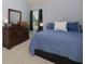 Cozy main bedroom features plush carpet and a large dresser with a mirror at 633 N Fairfield Dr, Peachtree City, GA 30269