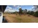 Expansive backyard view with mature trees, lawn, and an open horizon under a partly cloudy sky at 1027 Goza Rd, Fayetteville, GA 30215