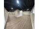 Spacious finished basement with wood-look flooring, exposed ceiling and recessed lighting at 1027 Goza Rd, Fayetteville, GA 30215