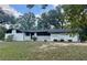 Charming single-story home with white painted brick and mature trees at 1027 Goza Rd, Fayetteville, GA 30215