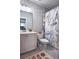 Well-lit bathroom featuring a single sink vanity and decorative shower curtain at 1116 Heatherland Dr, Marietta, GA 30066