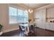 Bright breakfast nook features hardwood floors, chandelier, and glass table with seating at 1116 Heatherland Dr, Marietta, GA 30066