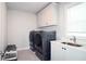 Modern laundry room with gray washer and dryer and plenty of storage space at 1116 Heatherland Dr, Marietta, GA 30066