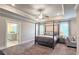 The primary suite has a tray ceiling, large windows, and a connected bathroom at 1116 Heatherland Dr, Marietta, GA 30066
