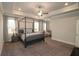 Spacious primary bedroom with sitting area features tray ceiling and plush carpeting at 1116 Heatherland Dr, Marietta, GA 30066