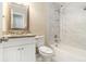 Bright bathroom featuring a white vanity with granite countertop and a tub-shower with tiled surround at 1702 Danrich Dr, Decatur, GA 30032