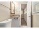 Cozy bathroom with a white vanity and doorway to an adjoining room with carpet flooring and natural light at 1702 Danrich Dr, Decatur, GA 30032