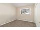 Simple bedroom with neutral walls, carpet, a window with blinds, and a white closet door at 1702 Danrich Dr, Decatur, GA 30032
