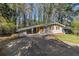 Street view of single-story home with covered parking and mature trees at 1702 Danrich Dr, Decatur, GA 30032