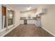 Bright kitchen featuring white cabinets, granite counters, and wood-look flooring at 1702 Danrich Dr, Decatur, GA 30032