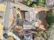 An aerial view of a house with a dark roof, driveway, and mature trees at 1905 Castleway Ne Ln, Atlanta, GA 30345